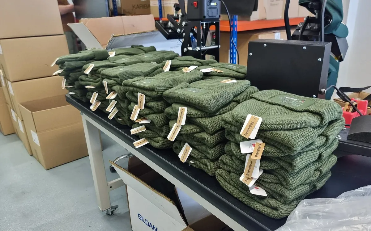 Finished batch of pieces with tags laid out on the table before inspection and packing